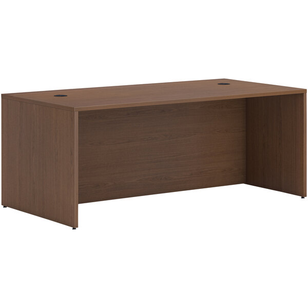 A brown HON Mod laminate desk shell with a wooden top.