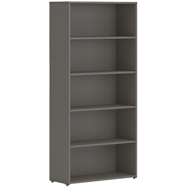 A slate teak laminate bookcase with five shelves.