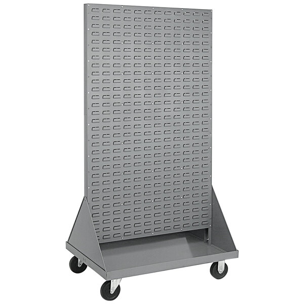 A grey metal cart with louvered shelves and wheels.