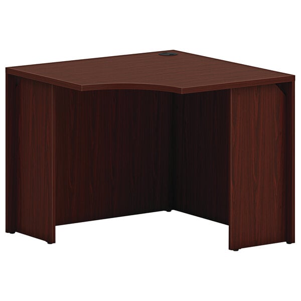 A HON traditional mahogany laminate corner desk shell.