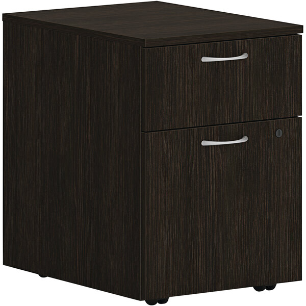 A Java Oak HON mobile pedestal filing cabinet with 1 file drawer.