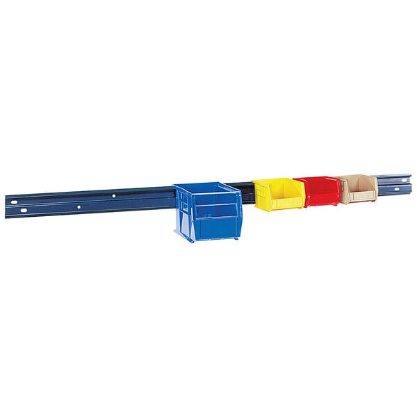 A Quantum grey steel wall-mount storage rail with a blue and yellow tool rack holding three different tools.