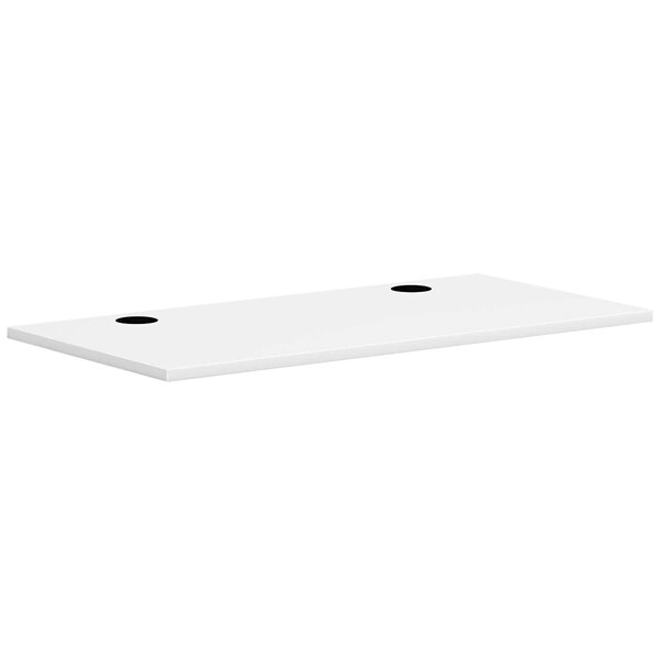 A white rectangular HON worksurface with two black holes.