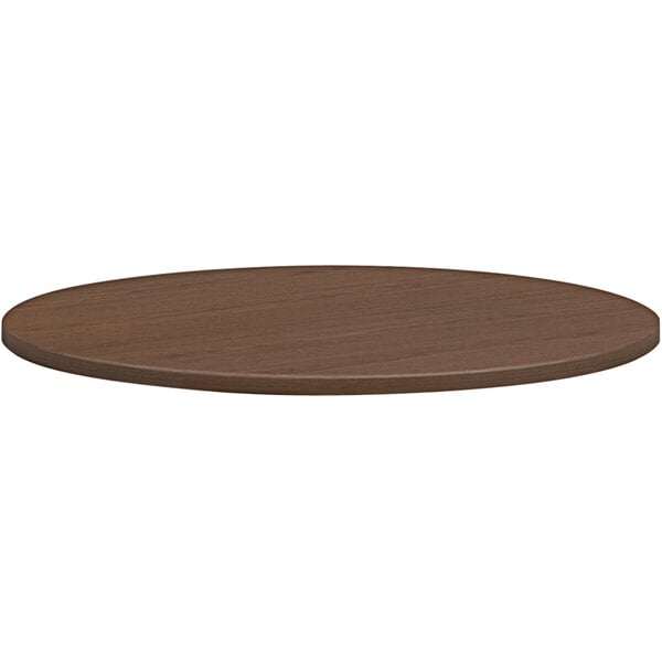 A HON sepia walnut round conference table top.
