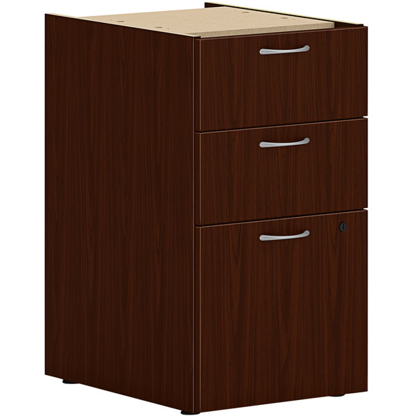 A traditional mahogany HON file cabinet with a box and file drawer.