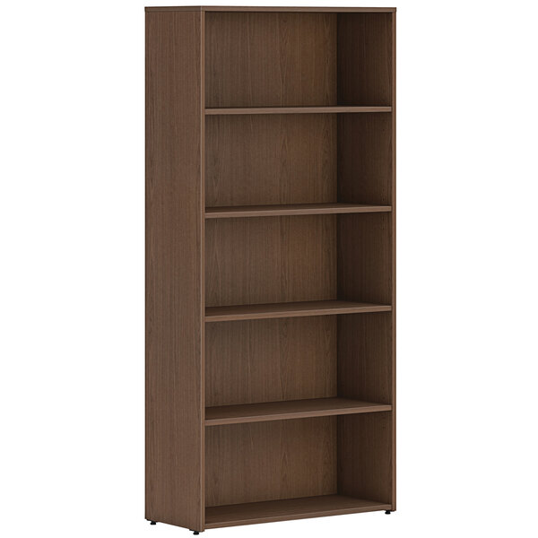 A HON Sepia Walnut laminate bookcase with four shelves.