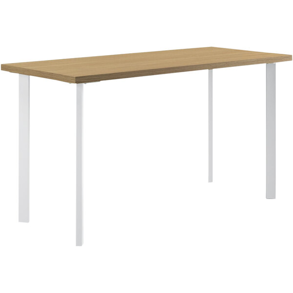 A HON Coze desk with a natural wood top and white legs.