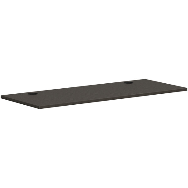 A rectangular black slate worksurface with two holes.