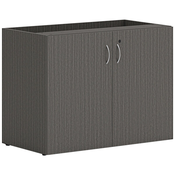 A slate gray HON storage cabinet with two doors and two drawers with silver handles.