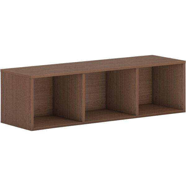 A brown HON wall mounted laminate open storage cabinet with three shelves.