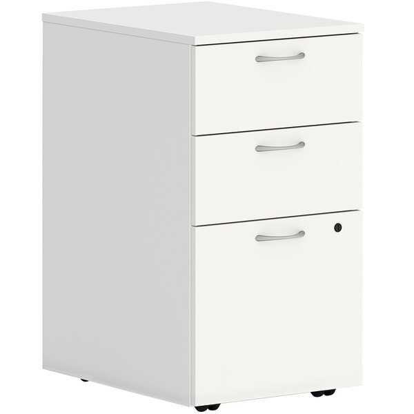 A HON Simply White mobile pedestal with 3 drawers and silver handles on wheels.