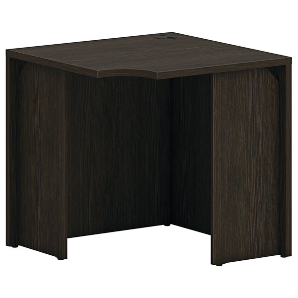 A HON Mod square oak laminate corner desk shell in java oak finish.