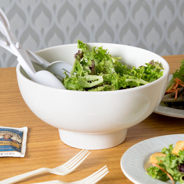 A bowl of vegetable salad on a table with American Metalcraft Prestige porcelain footed bowl.