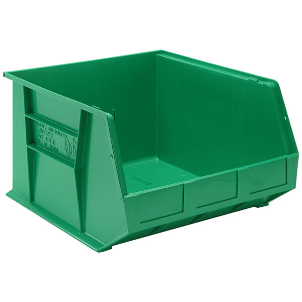 A green plastic bin with text on the front reading "Quantum" and "QUS270GN" hanging on a white shelf.