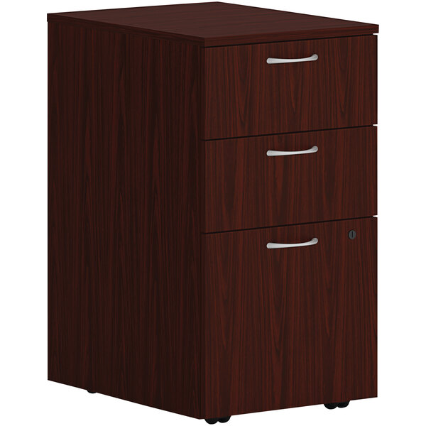 A traditional mahogany HON mobile pedestal with 2 box drawers and 1 file drawer.