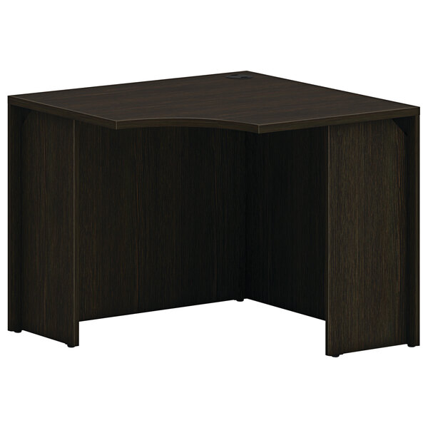 A black corner desk with a java oak finish.