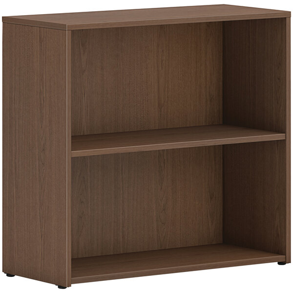 A brown HON laminate bookcase with two shelves.