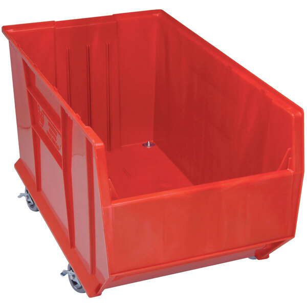 A Quantum red plastic storage bin with wheels.