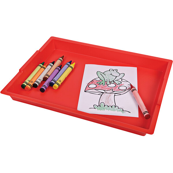 A red Deflecto kids finger paint tray with crayons on it.