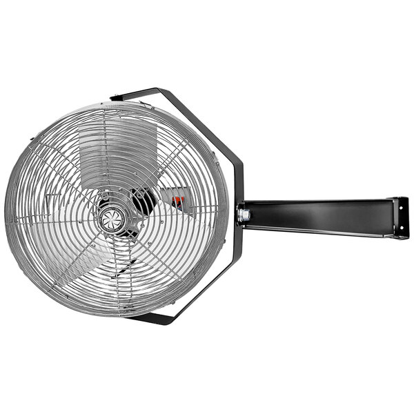 A black TPI industrial wall-mounted fan.