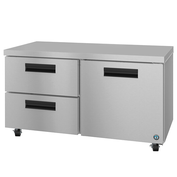 A stainless steel Hoshizaki undercounter refrigerator with one door and two drawers with black handles.