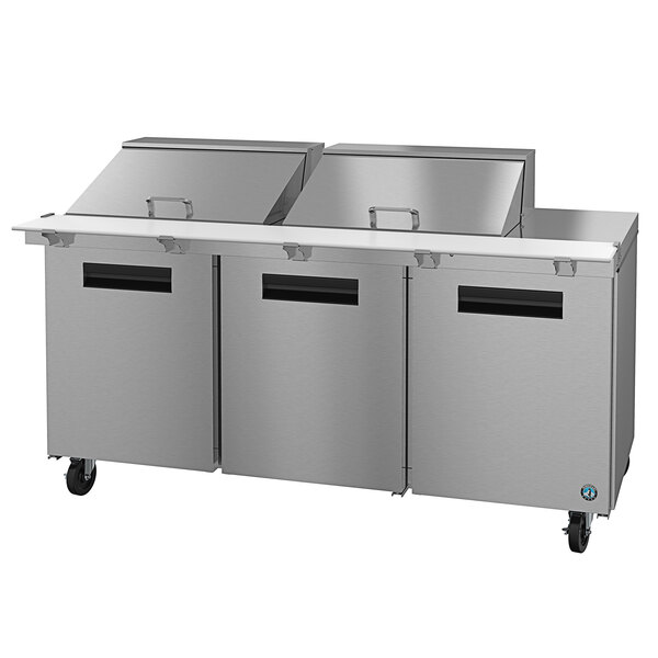 A large stainless steel Hoshizaki refrigerated salad prep table with wheels.