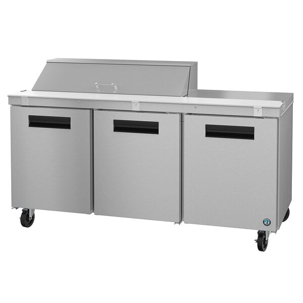 A stainless steel Hoshizaki refrigerated sandwich prep table with two doors and food pans inside.