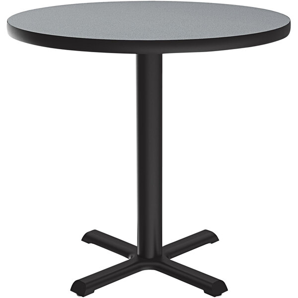 A Correll round table with a black base and grey granite finish top.