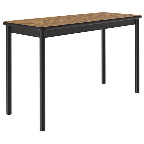 A Correll medium oak lab table with black legs.