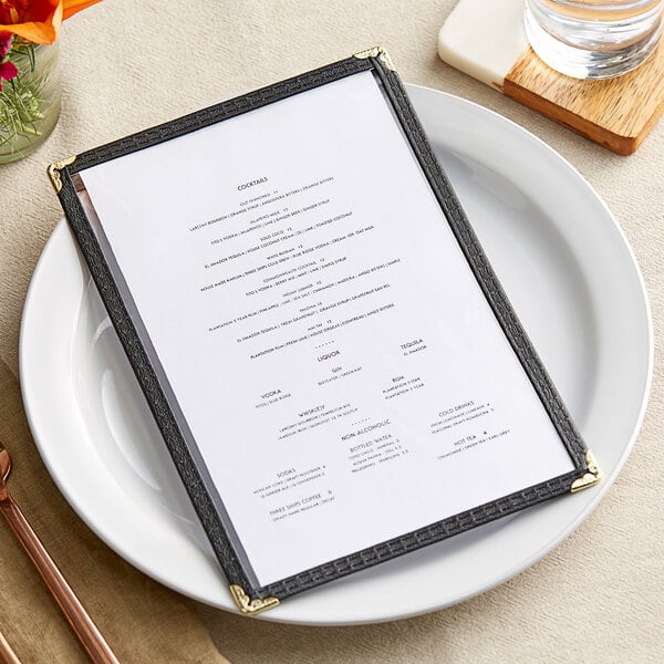 A black menu cover on a white plate.