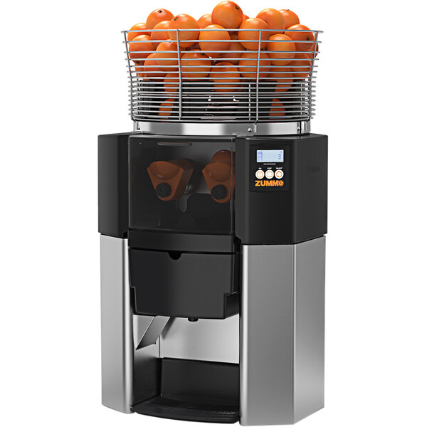 A black and silver Zummo commercial juicer with a basket of oranges in it.
