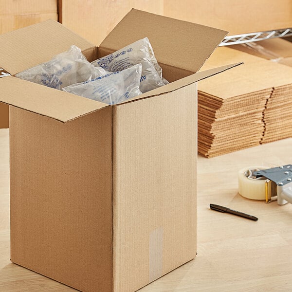 A Lavex kraft corrugated cardboard shipping box filled with plastic bags.