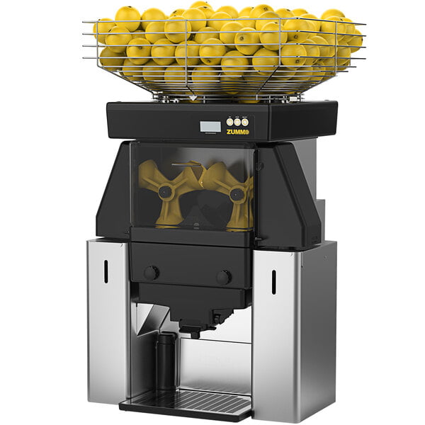 A Zummo Z40 commercial juicer with a basket of yellow fruits.