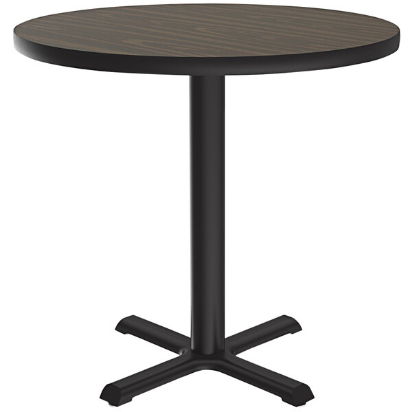 A Correll round table with a black base and walnut finish top.