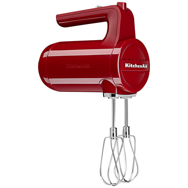 A red KitchenAid cordless hand mixer with a handle.