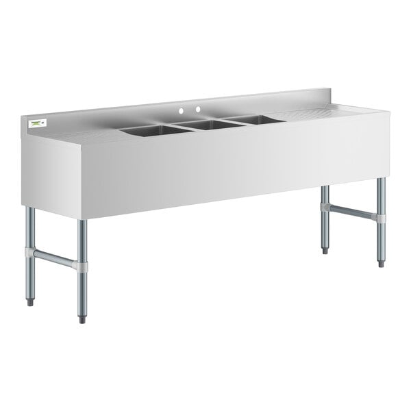 A stainless steel Regency underbar sink with three large compartments and two large drainboards.