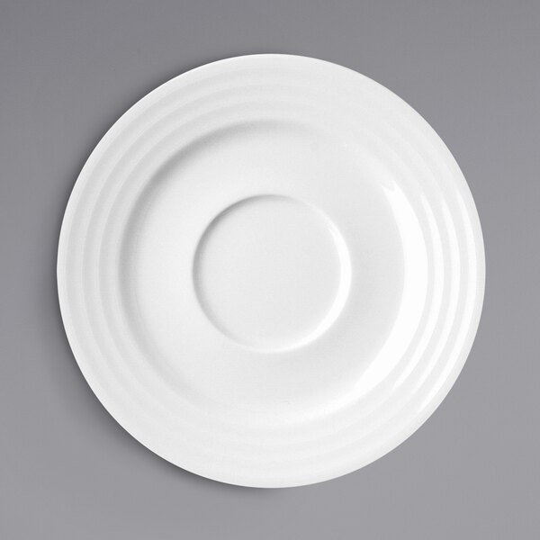 A white RAK Porcelain saucer with a circular pattern.