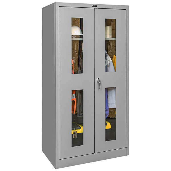 A gray metal Hallowell wardrobe cabinet with glass doors.