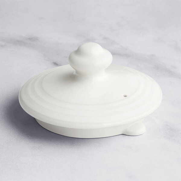 A close up of a RAK Porcelain white round lid.
