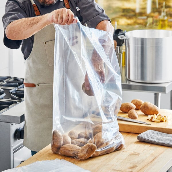 A man holding a Choice plastic food bag filled with potatoes.