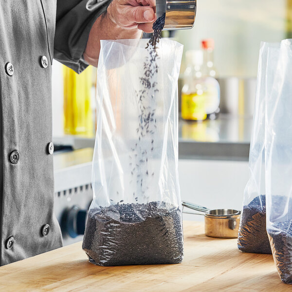 A chef pouring black rice into a Choice plastic food bag.