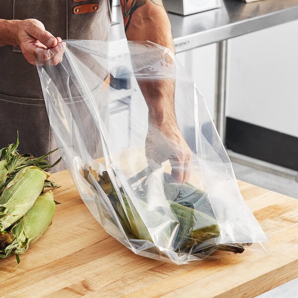 A person holding a Choice heavy-duty plastic bag of corn on the cob.