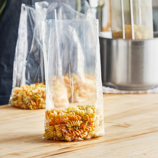 A box of Choice medium-duty plastic bags filled with pasta on a table.