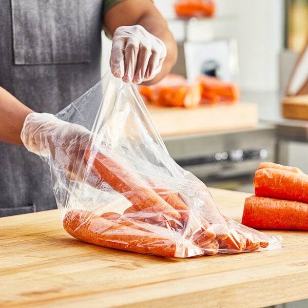 A person in gloves holding a Choice plastic bag of carrots.