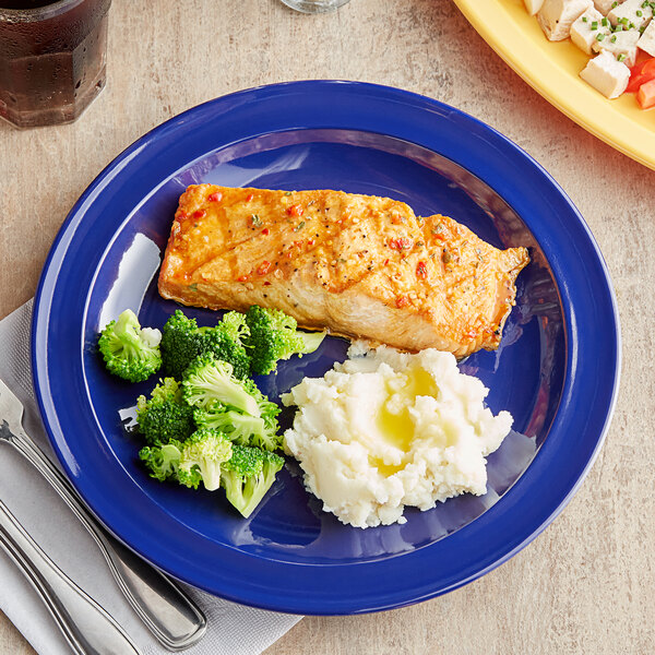 A blue Acopa Foundations narrow rim melamine plate with broccoli, mashed potatoes, and chicken.