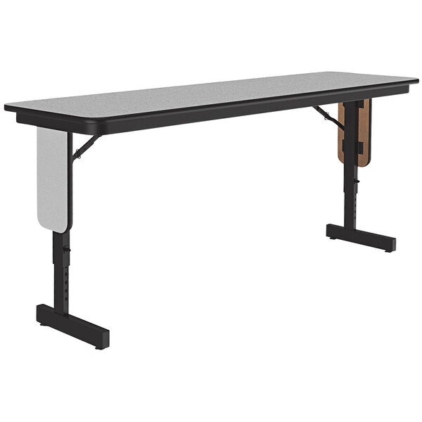A grey rectangular Correll seminar table with black panel legs.
