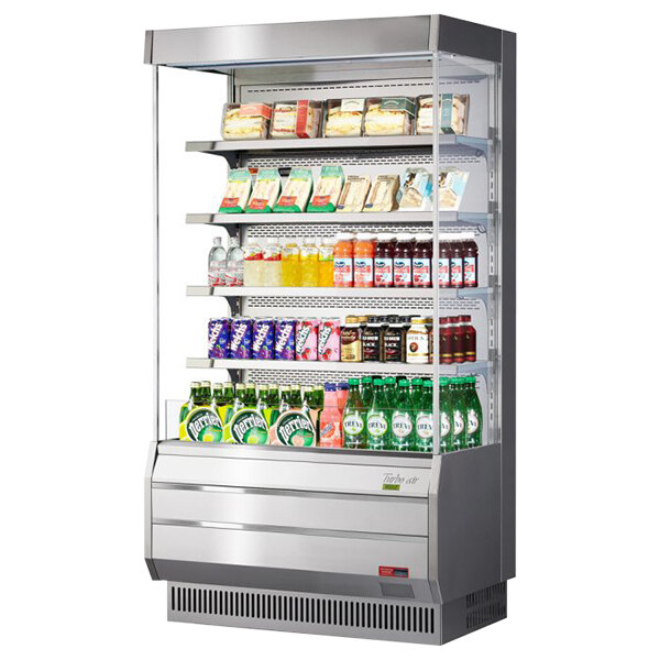 A Turbo Air stainless steel vertical refrigerated display case with drinks and beverages.