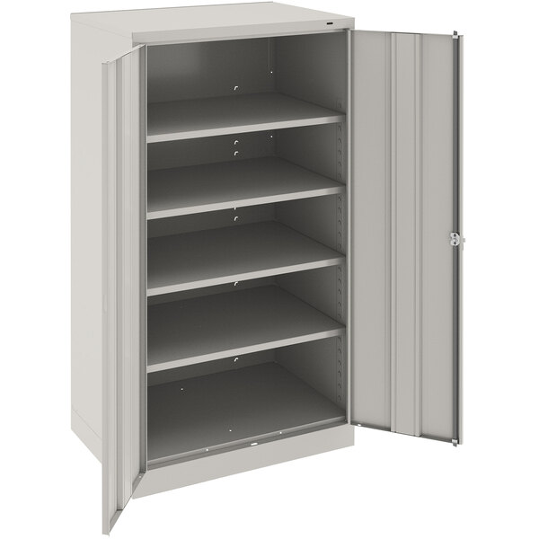 A Tennsco light gray metal storage cabinet with solid doors.