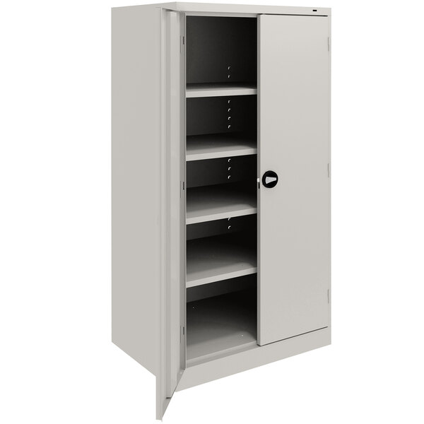A light gray Tennsco metal storage cabinet with shelves.