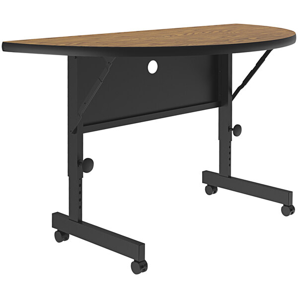 A Correll half round oak seminar table with adjustable height and wheels.